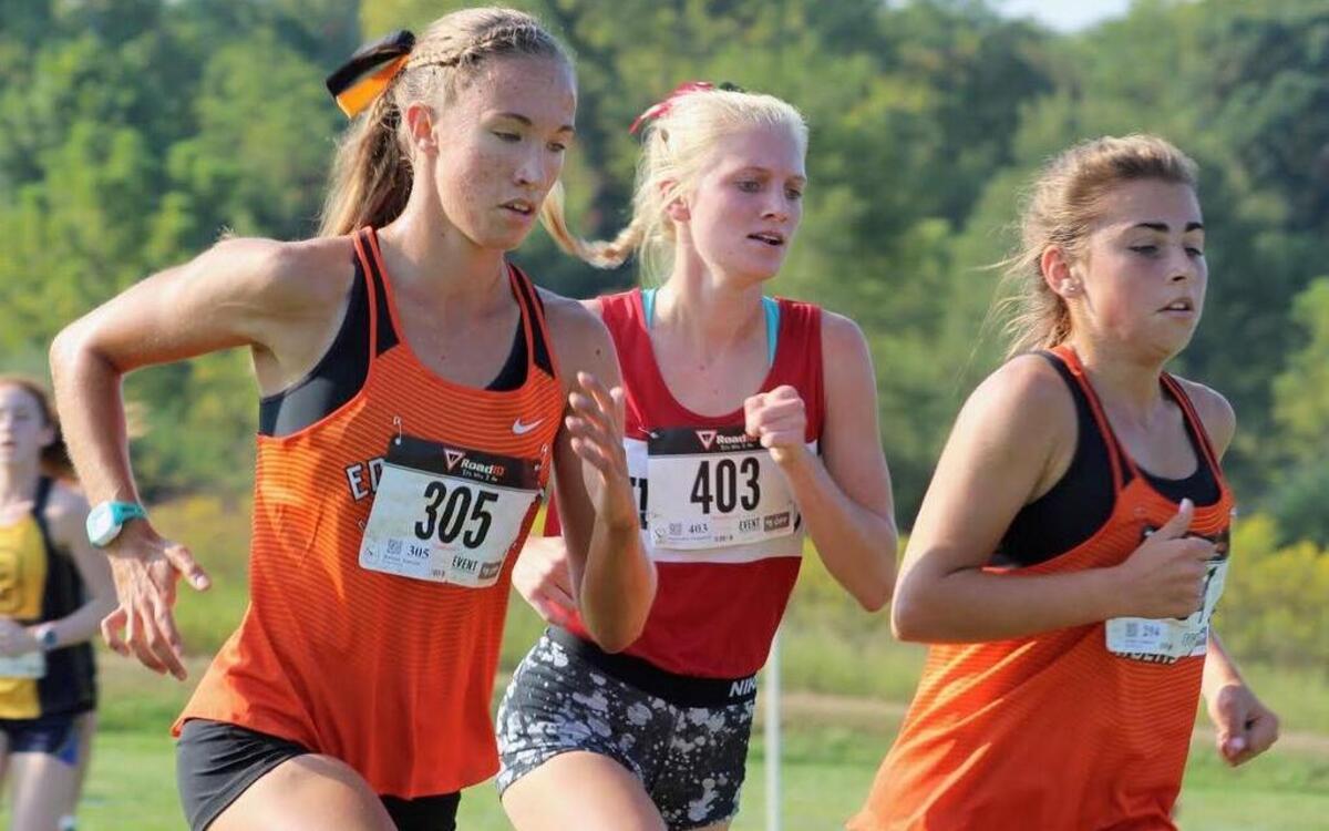 Highland sophomore Sam Hengehold, middle, runs between two Edwardsville runners en route to placing eighth out of 153 runners at the Edwardsville Invitational Saturday, Sept. 16 at Southern Illinois University Edwardsville.