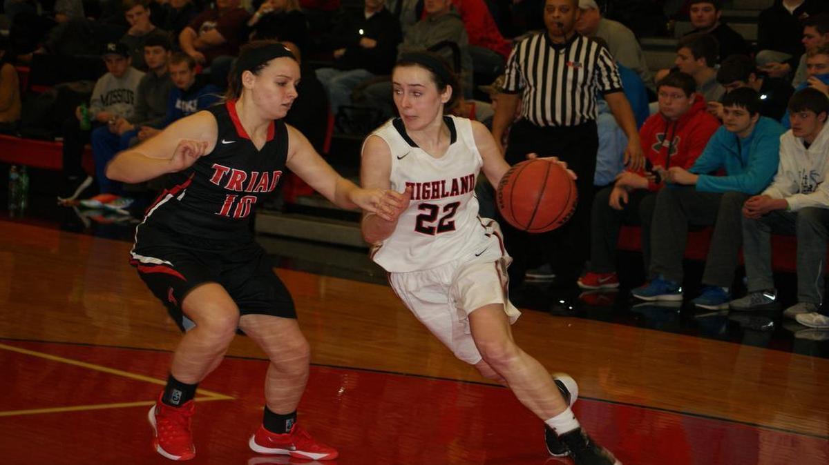 Highland junior Madison Wellen drives the baseline on Triad junior Samantha Bassler during the second half of the Lady Bulldogs’ 56-50 victory over visiting Triad at the 30 th annual Highland Optimist Shootout Saturday at HHS.