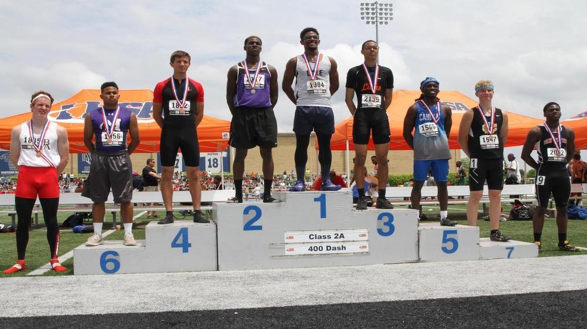Highland senior Brode Porell, third from left, stands in fourth place on the podium at the IHSA Class 2A Boys State Track Meet Saturday at Eastern Illinois University.