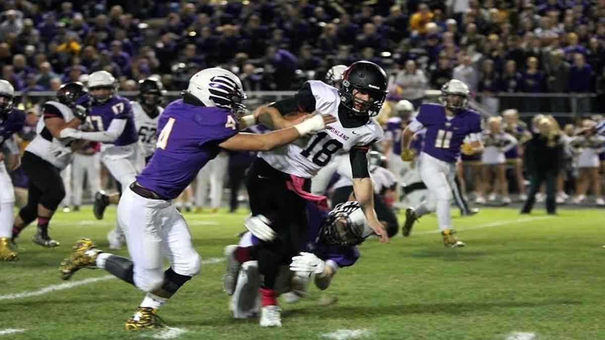 
Highland sophomore quarterback Garrett Marti plows for extra yardage during the Bulldogs’ 35-27 victory at Civic Memorial Friday night.
