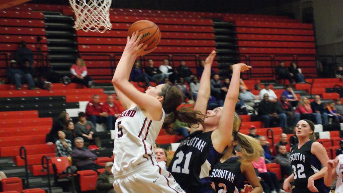 Highland senior Amanda Ponce gets inside of Mascoutah’s Kennedy Bryant for two of her game-high 17 points during the first half of the Lady Bulldogs’ 57-34 win in the championship game of the IHSA Class 3A Triad Regional Thursday.
