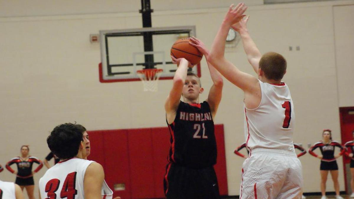 Highland senior Austin Elledge shoots over Triad sophomore Beau Barbour during the first half of the Bulldogs’ 66-48 victory over the host Knights on Tuesday.