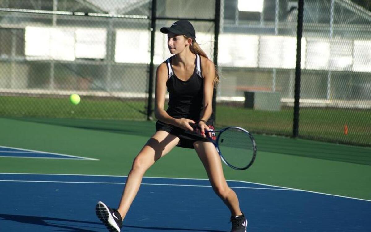 Highland senior Anjuli Kampwerth, shown hitting a backhand against Mascoutah on Tuesday of last week, teamed with Mia Walters to win both of their doubles matches last week and help the Bulldogs edge Roxana and Mascoutah.