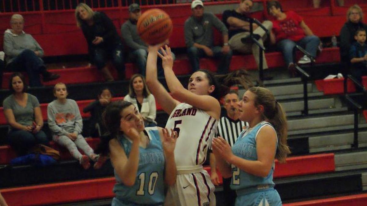 Highland sophomore guard Ellie Brown shoots and scores over Jerseyville’s Abby Manns (10) and Brooke Tuttle (2) during the first half of the Lady Bulldogs’ 65-41 home win over the Panthers Monday night at HHS.