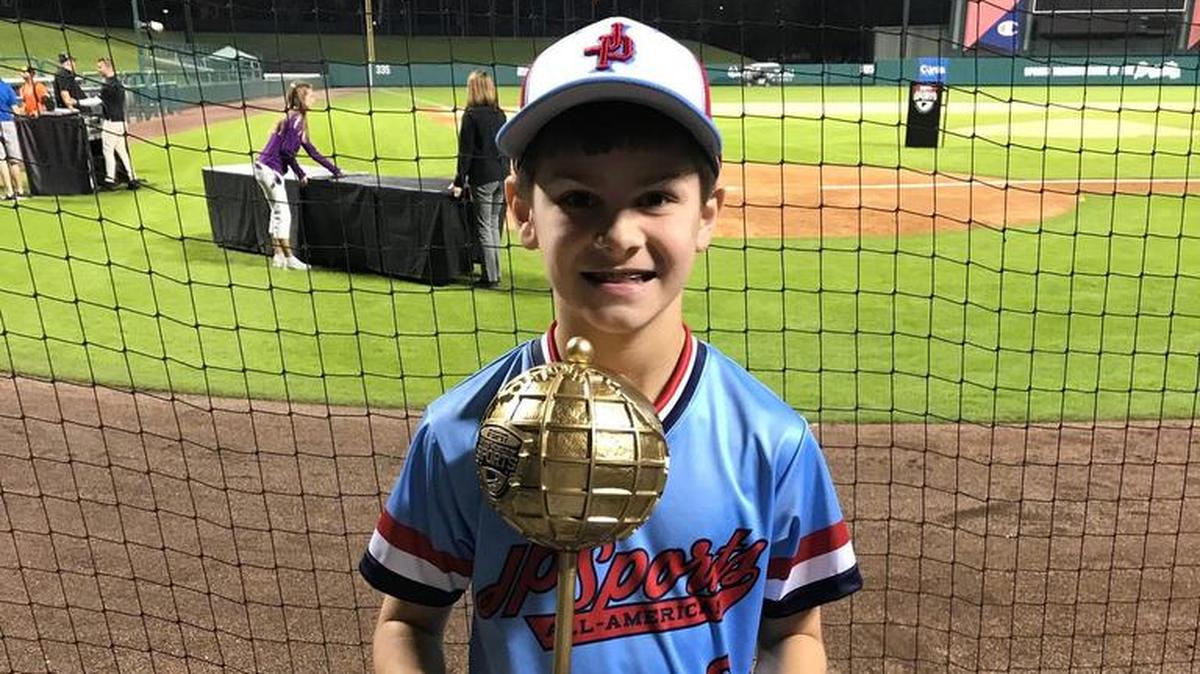 Brayden Bircher, 11, of Highland proudly displays his trophy for being one of four players who teamed up to win the Mickey’s Around the Horn competition, which was part of the Disney New Year Baseball Clinic 2017 Skills Competition held at ESPN’s Wide World of Sports Complex in Walt Disney Resort in Bay Lake, Fla, which is near Orlando.