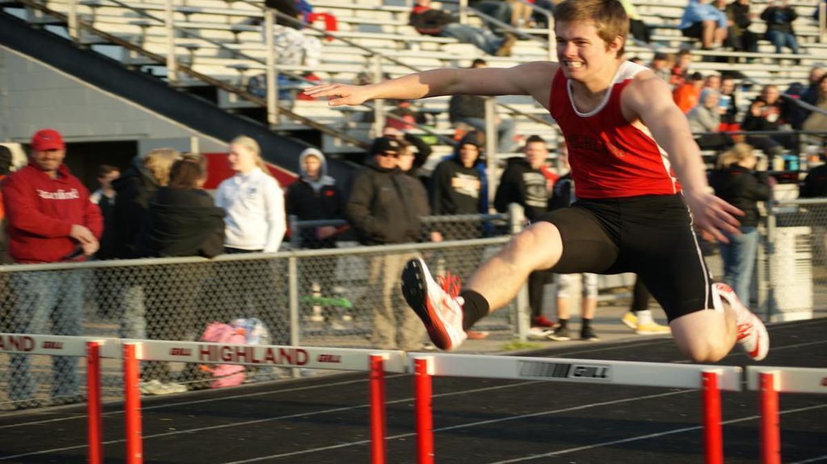 Highland sophomore Noah Schmitt clears a hurdle en route to taking third place in the 300-meter low hurdles at a triangle meet Tuesday at HHS.