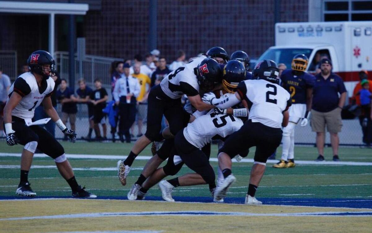 Highland junior free safety Sam LaPorta watched as his defensive teammates gang tackle Marion tight end Wyatt Fox. Pictured on the tackle for the Bulldogs from left are senior Seby Wolf (34), senior Noah Schmitt (facing the camera in the back), junior Jack Etter (15) and senior Kyle Lane (2)