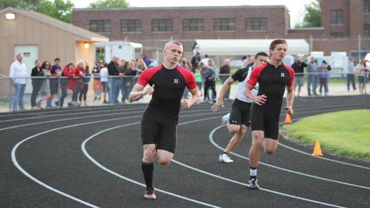 Highland junior Tyler Higgins, left, and senior Brode Portell run close together en route to taking first and second in the 400 meters Friday at the IHSA Class 2A Springfield Lanphier Boys Track and Field Sectional. Higgins also claimed sectional titles in the 100- and 200-meter dashes to capture the Triple Crown of Sprinting.
