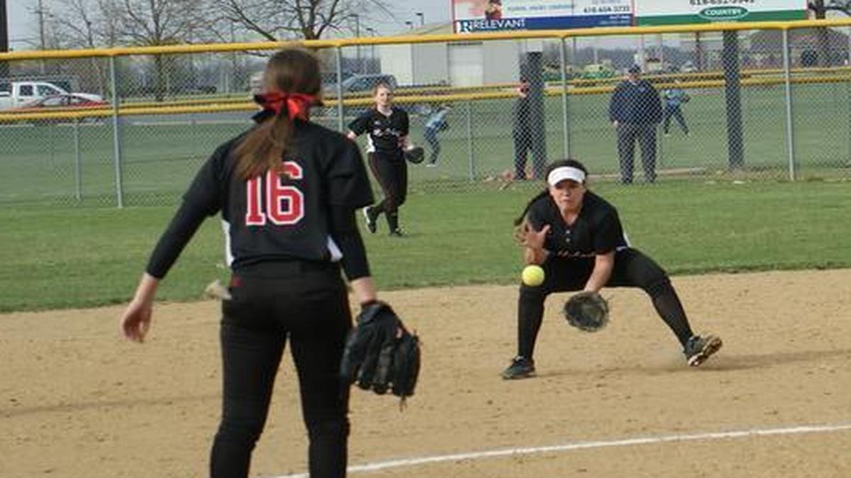 Highland freshman shortstop Lily Garbett fields a ground in the third inning as junior pitcher Aubrey Hacke looks on during the Lady Bulldogs’ 1-0 home loss to Belleville East on Wednesday at HHS.