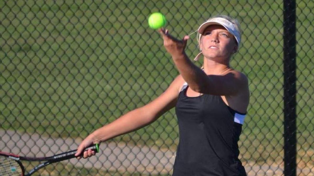 Highland junior Kirsten Plocher is shown tossing up the ball for a serve during a match this season while competing as the Lady Bulldogs’ No. 1 player.