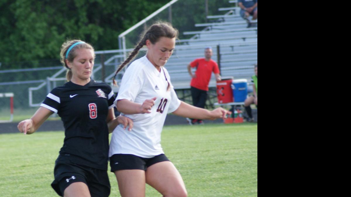
Highland senior Rebecca Nation works to control the ball in front of Triad junior Allison Wendt last Thursday during Senior Night at HHS.
