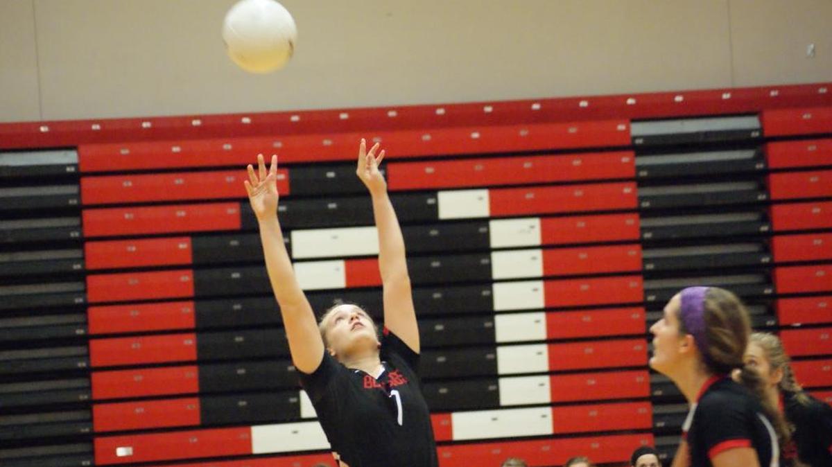 Highland senior setter Sami Beyer, shown recently setting the ball atTriad, dished out a match-best 22 assists in a 25-10, 25-21 win at Jerseyville on Tuesday of last week. In the foreground is junior middle hitter Alex LaPorta.