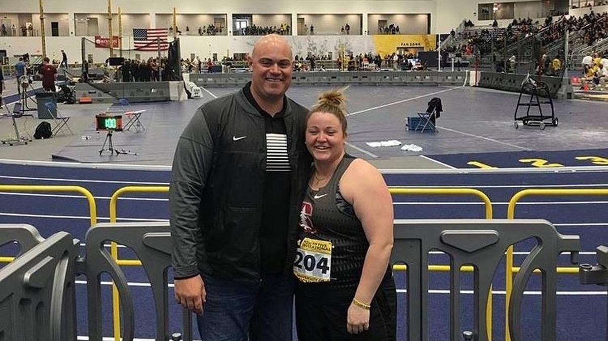 Stanford University senior Lena Giger takes a photo with her throwing coaching Zeb Sion after setting a new personal record in the shot put with a throw of 56 feet, 10.75 inches to win the Power Five Invitational indoor track and field meet Saturday at the University of Michigan in Ann Arbor, Mich.