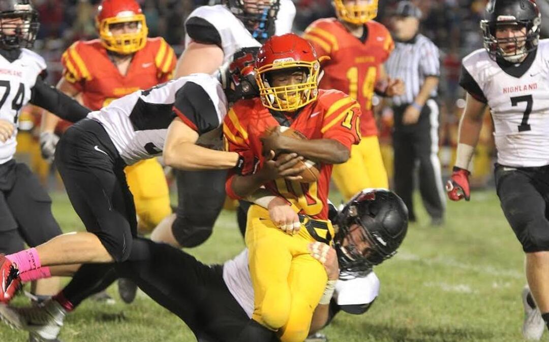 Highland sophomore linebackers Kyle Lane, bottom, and Selby Wolf, top, combine to tackle Charleston senior running back Kevin Beard during the Bulldogs’ 45-0 road victory last Friday night.