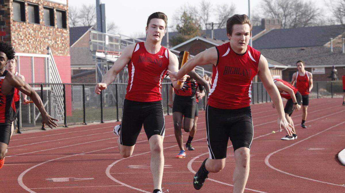 Highland senior Seby Wolf, left, is shown handing the baton to fellow senior Chase DeProw earlier this season at Granite City. The duo teamed up with seniors Mason Geiger and Noah Schmitt to win the 4x 100-meter relay race at Jerseyville on Wednesday, April 11.