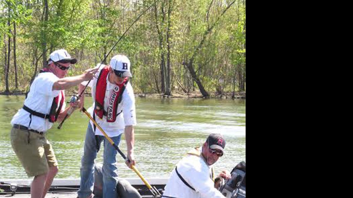 
Highland junior Hampton Dufrain lands a fish with the help of fellow junior Blake Schumacher netting it as coach Jon Rinderer drives the boat.
