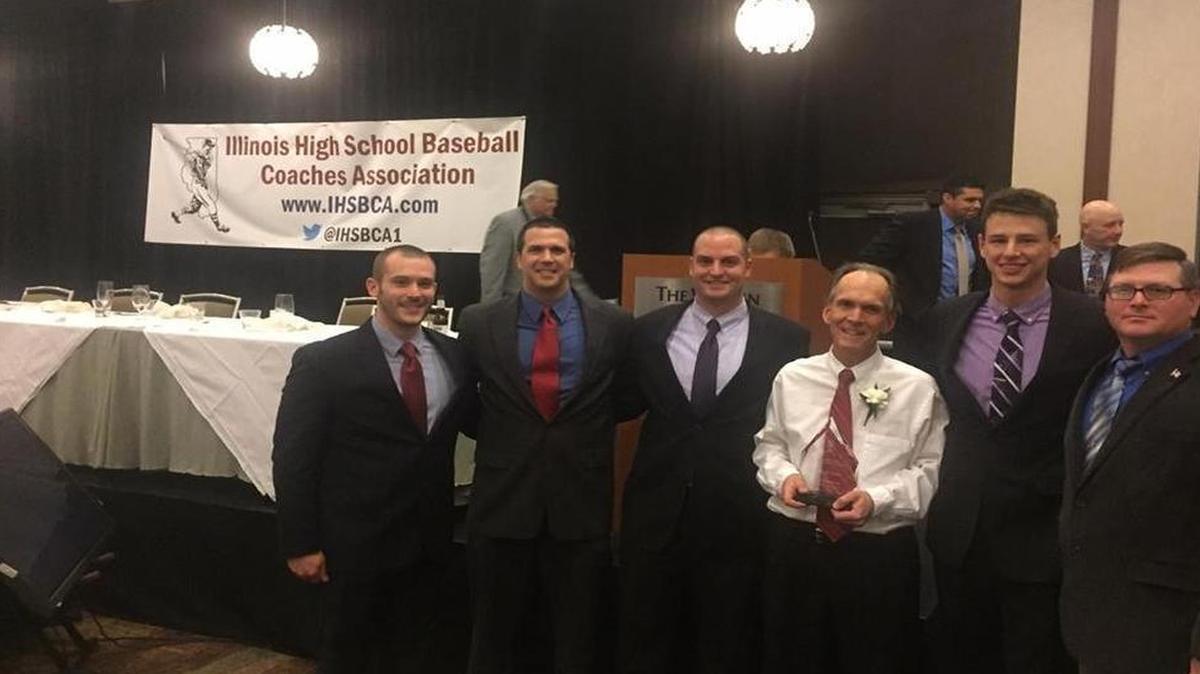 Highland High School veteran baseball coach Joel Hawkins, holds his award after being inducted into the Illinois Baseball Coaches Hall of Fame Saturday night in Lombard, Ill. Pictured from left to right are former HHS baseball player Brandon Koishor, HHS assistant baseball coach Sam Weber, former HHS baseball player Danny Gifford, coach Hawkins, and former HHS baseball players Derek Reckmann and Fred Zobrist, who was a team member on Hawkins’ first team when he took over the top position in the program in the spring of 1992.