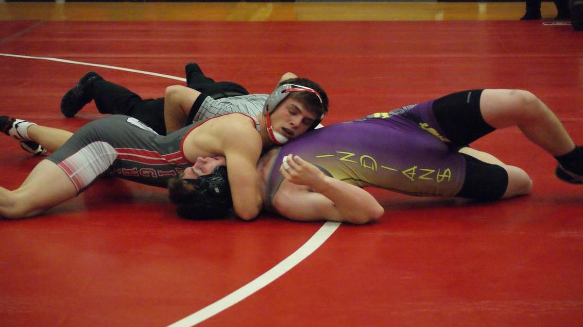 Highland senior Trent Rakers, shown about to pin Carlyle’s Bryce Marlow in the first period this past season, was named the Belleville News-Democrat Co-Wrestler of the Year after going 35-0 and winning the Class 2A state championship at 152 pounds. Rakers will attend and compete on the mat for the Southern Illinois University Edwardsville Cougars next winter.