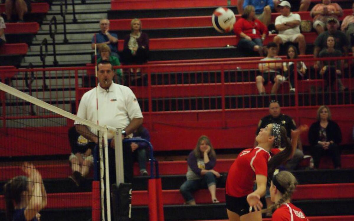 Highland junior middle hitter Claire Diercks gets ready to lower the boom on one of her seven kills as sophomore setter Megan Vidmar looks on from below during the second set of the Lady Bulldogs’ 25-13, 25-12 victory over visiting Civic Memorial Thursday night.