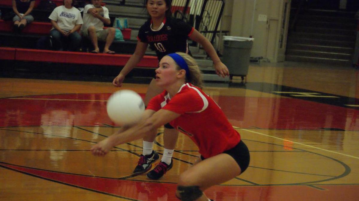 Highland senior left-side hitter Sarah Beth Wiegman bumps up a serve while sophomore libero Emmy Nyquist looks on during the Lady Bulldogs’ 25-14, 25-20 victory over visiting Collinsville Monday at HHS.