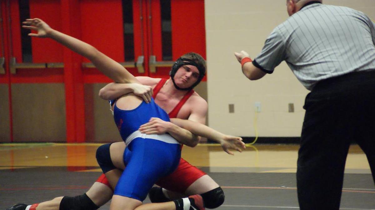 Highland junior Brett Brown locks up Cahokia’s Zakariah Al-Khamos before flinging him over on his back to pin him during their third-place match at 195 pounds at the IHSA Class 2A Triad Wrestling Regional Saturday at Triad High School.