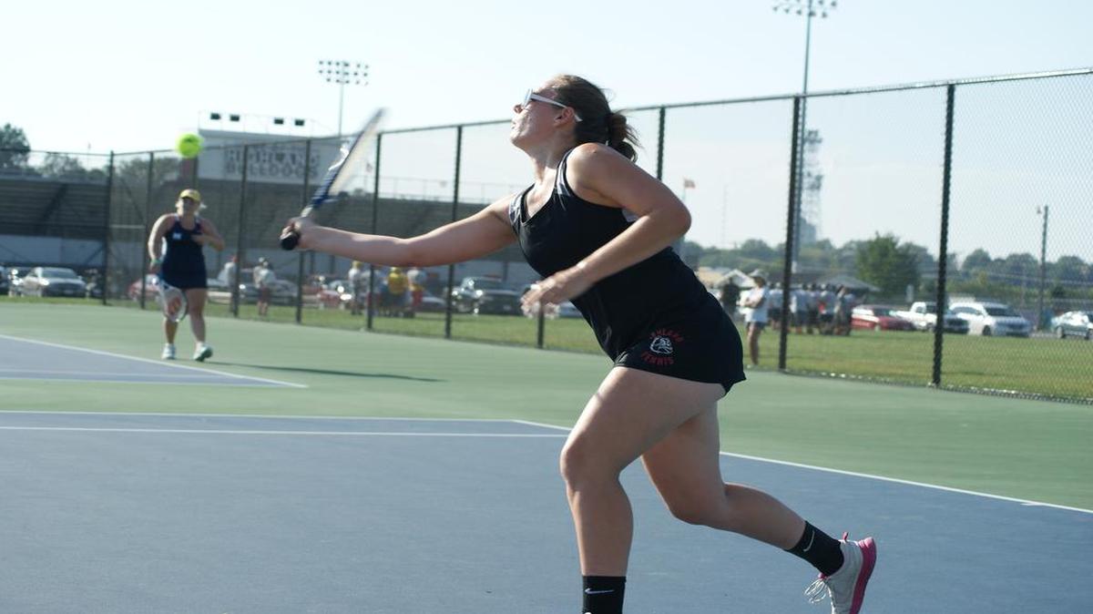 Highland senior Elisabeth Meadows moves in from the baseline to hit a volley for a winner in her 6-0, 6-4 victory over Alton Marquette’s Anne Tassanari in their No. 2 singles match last Thursday at HHS.
