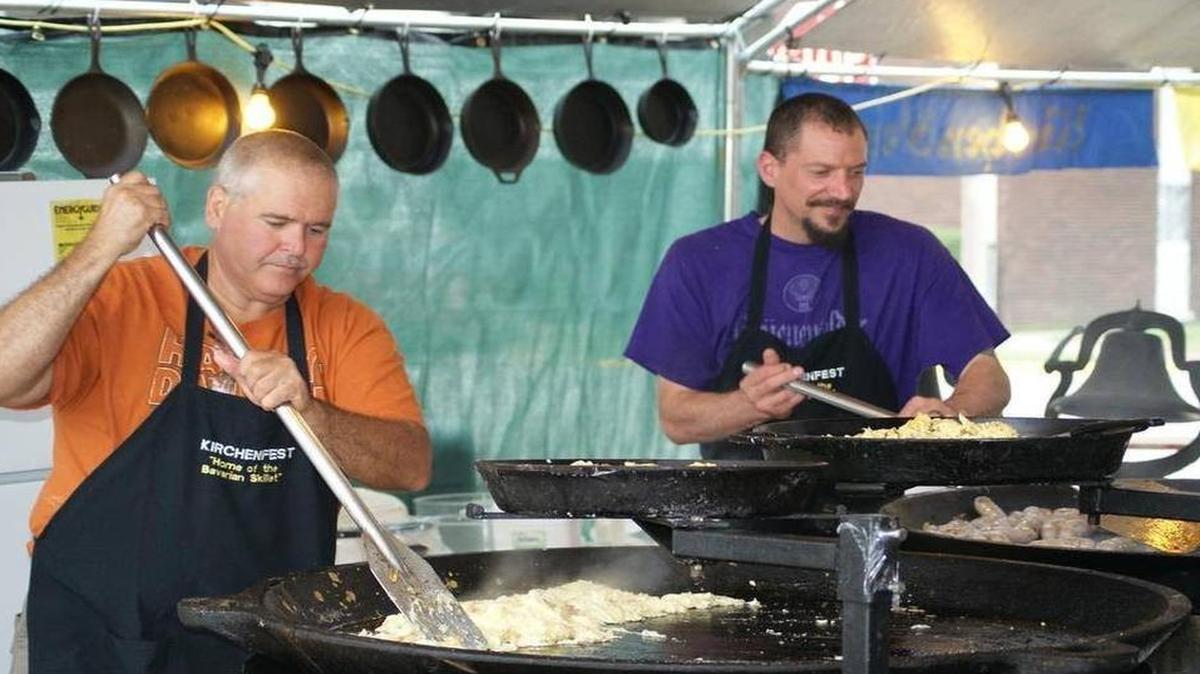 Don Frank, left, and Dan Palenchar cook up breakfast in the 528-pound Bavarian skillets at the 45th annual Kirchenfest Saturday morning at St. Paul Catholic Church in Highland.