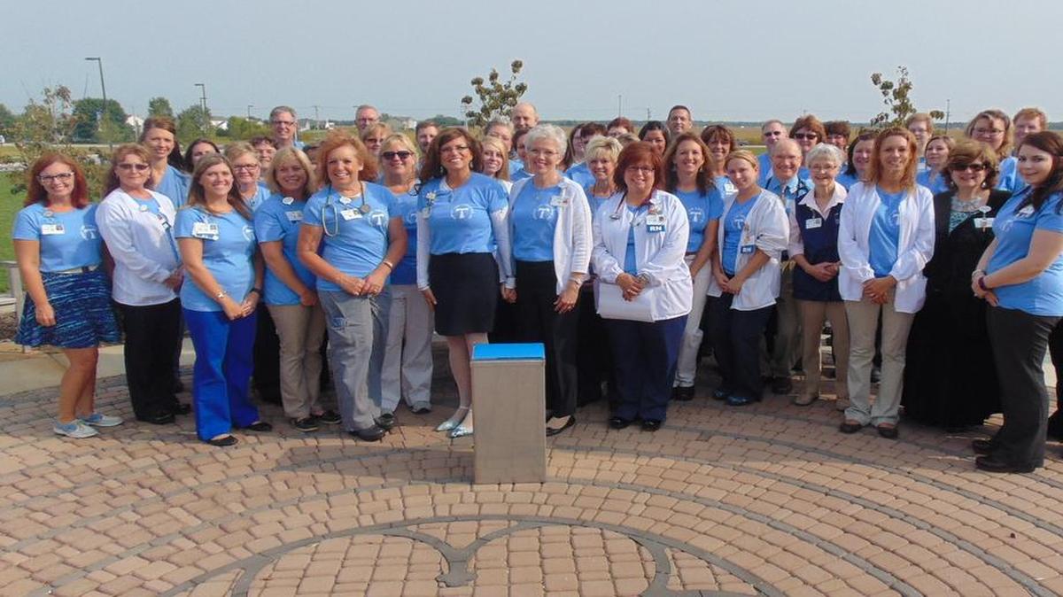 
Hospital Dedicates Third Time Capsule Peggy Sebastian, president and CEO of St. Joseph’s Hospital in Highland (pictured front center left), and Jeannie Korte, manager of spiritual care (pictured front center right), led colleagues in a time capsule dedication ceremony on Aug. 28, continuing a tradition from previous time capsule dedications held in 1948 and 1987. A commemorative plaque will be placed in the hospital’s Franciscan Healing Garden to mark the occasion. St. Joseph’s Hospital has been a part of Highland for 137 years. The latest SJH facility opened its doors in August 2013.

