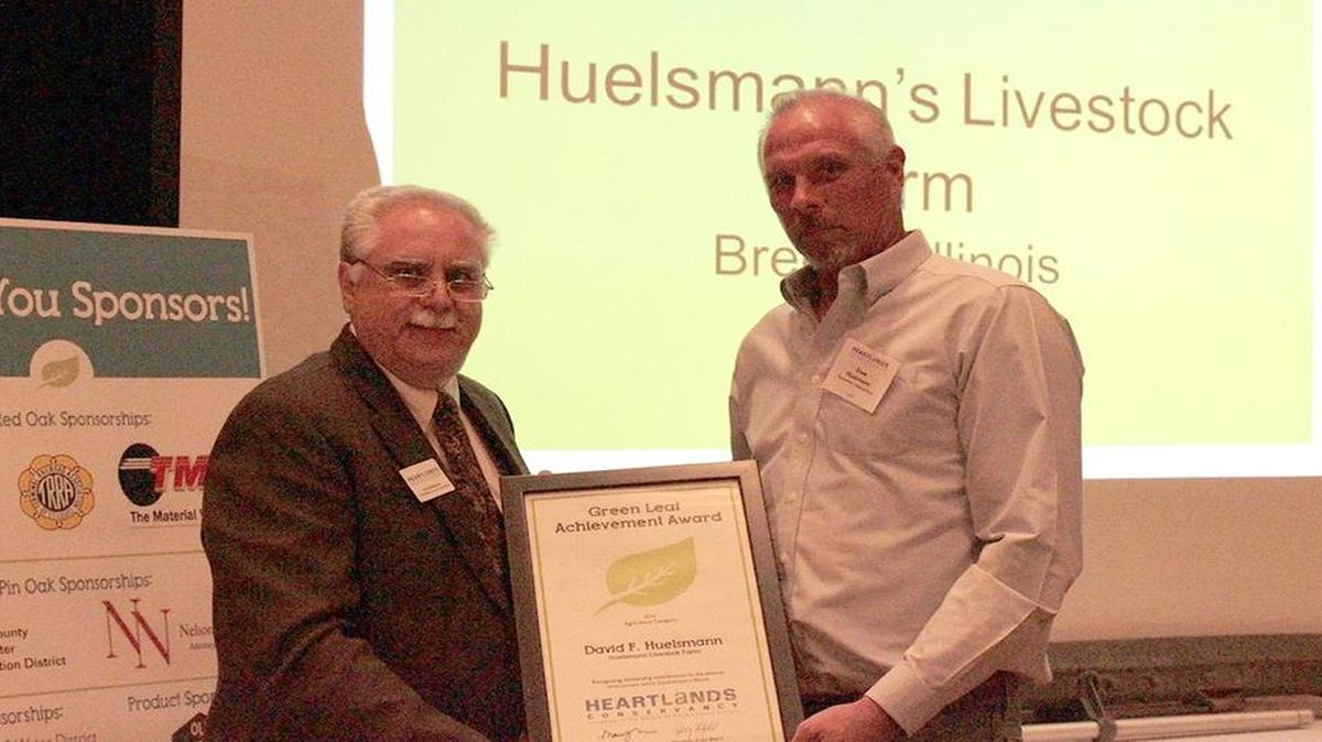Ed Weilbacher, left, vice president of Building Greener Communities for HeartLands Conservancy, presents the Agriculture “Leafie” to David Huelsmann.