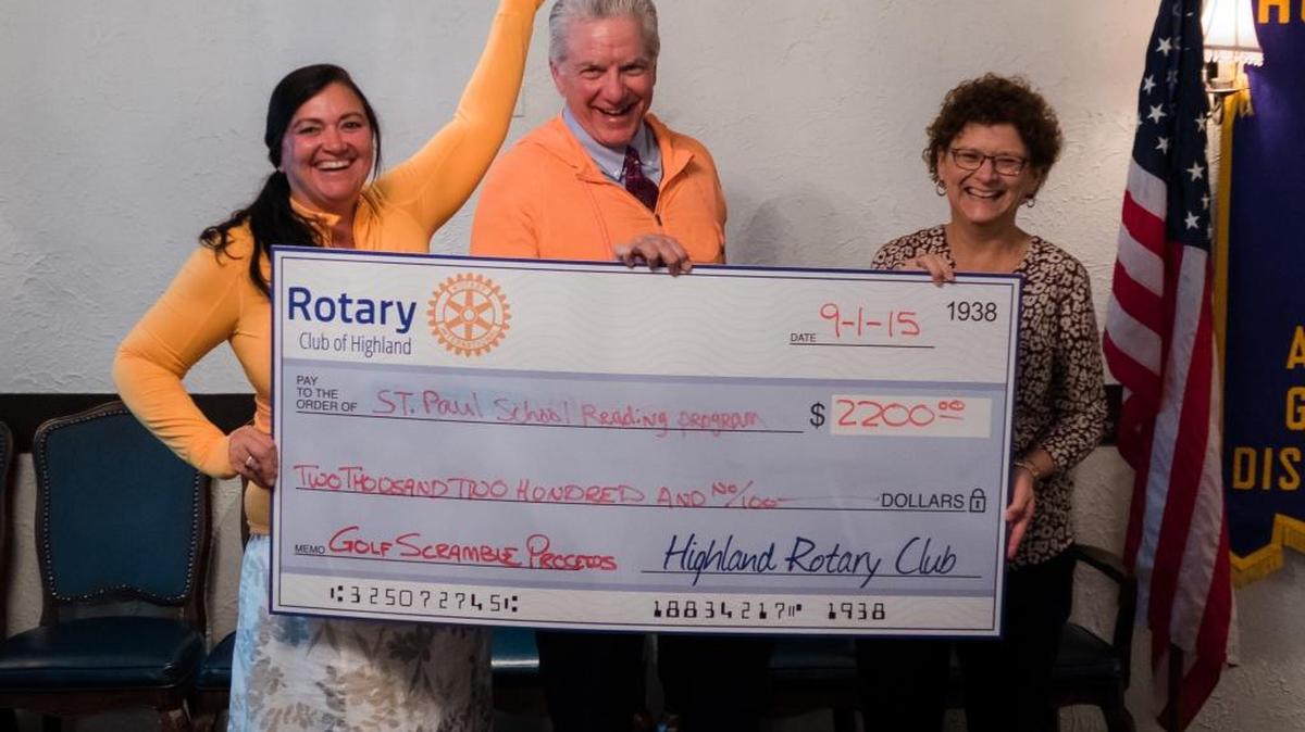 
Maura Donnelly and Kevin Dewaele present a $2,200 check to present a check to Kathy Sherman for the St. Paul School Reading Program.

