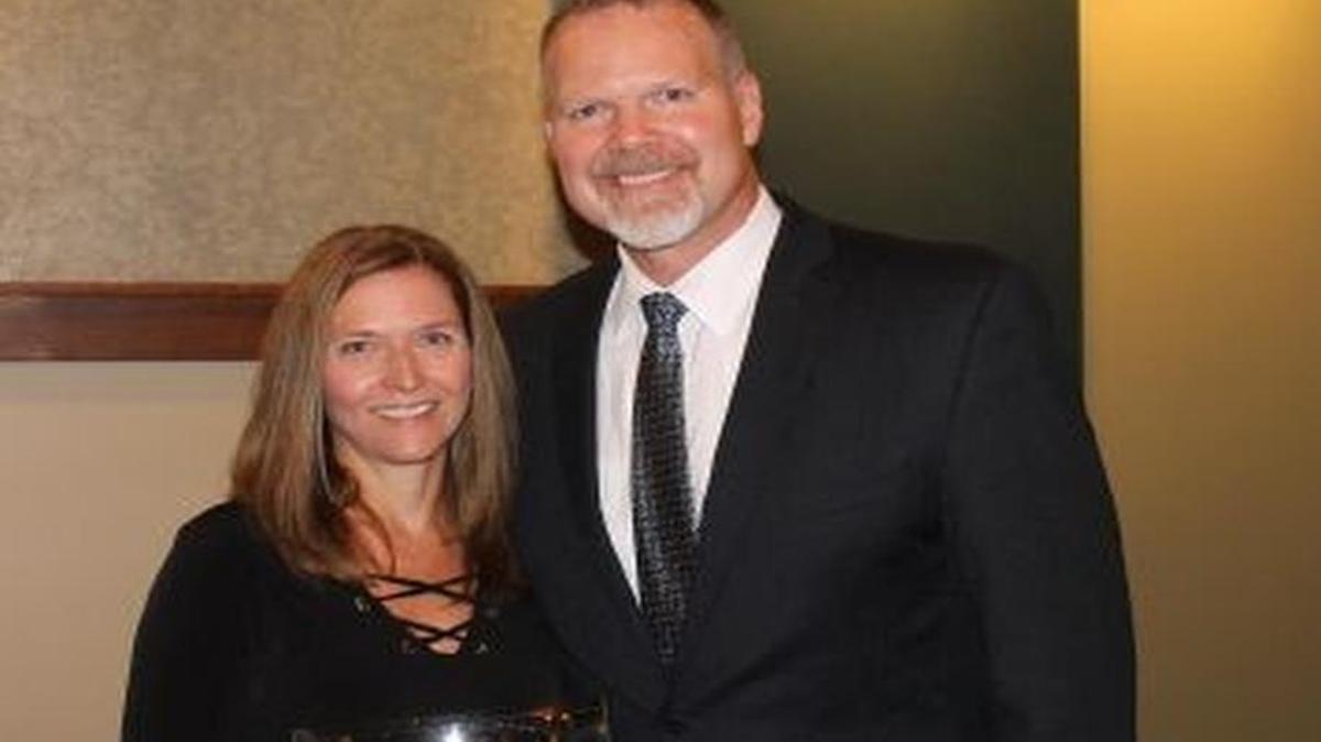 State Superintendent Dr. Tony Smith, right, presents Triad Superintendent Leigh Lewis with the “Superintendent of Distinction” award.