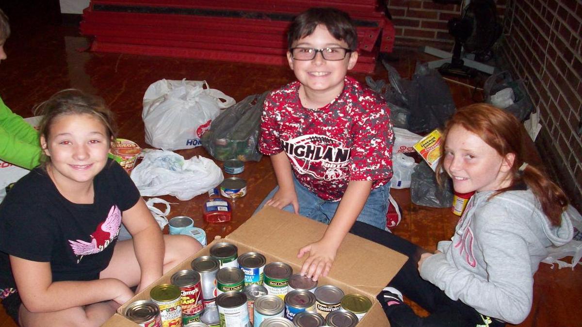 The Kids Care Club at Highland Elementary recently organized the school’s donations to the Food Pantry. From left are Cailey Roberts, Miguel Hately, Brandi Moss. This club is composed of fifth graders who will be doing community service throughout the school year.