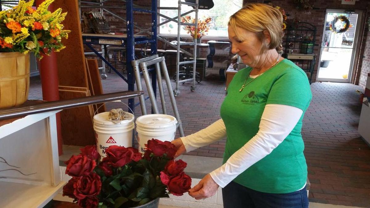 Retha Turner, the new owner of Widmer Floral, adjusts a bouquet of flowers. The business is undergoing renovations, and is expanding its offerings.