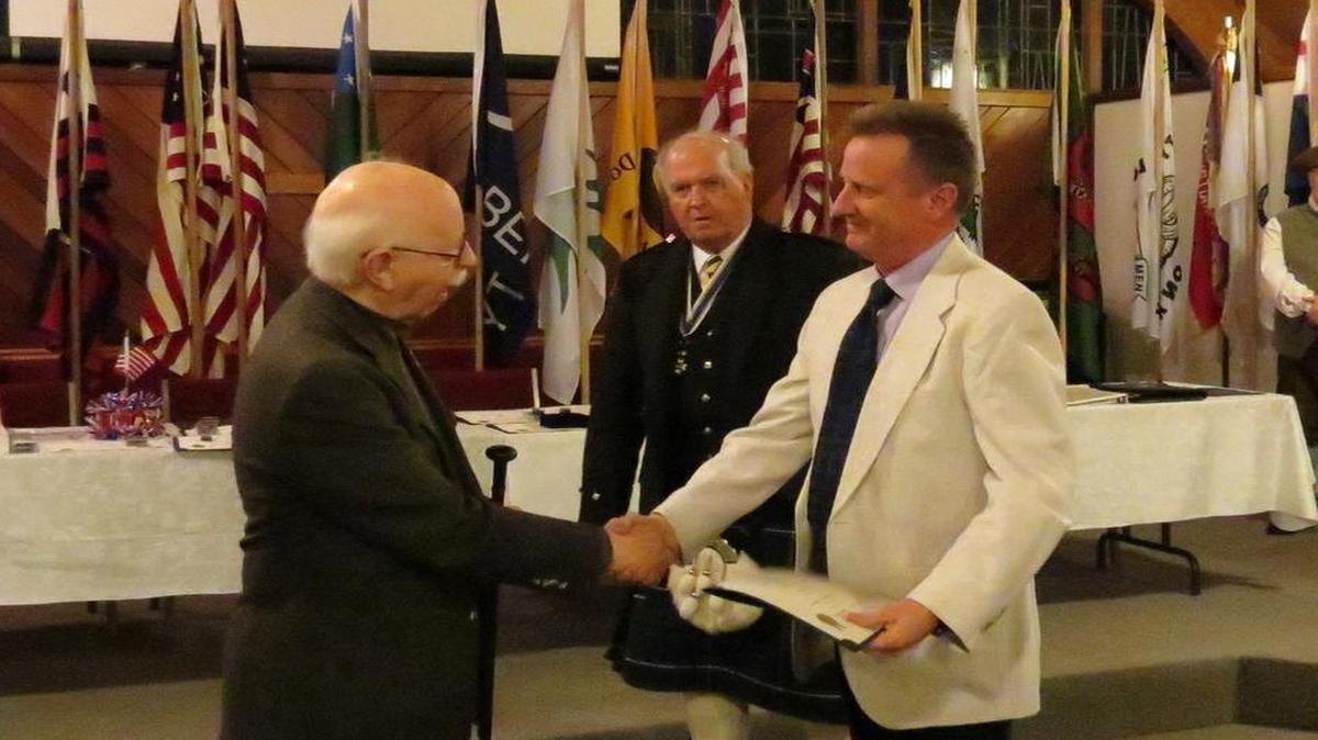 HERO AWARD Chapter chairman Lloyd Schwarz, left, presents the SAR Hero Award to Keith Mills. Looking on is chapter present Marvin Meng.