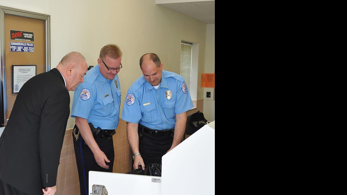 
Madison County Sheriff John Lakin, Edwardsville Chief Jay Keeven and Lt. Charles Kohlberg inspect the prescription drugs collected at the medication collection bin in the lobby of the Edwardsville Police Department.

