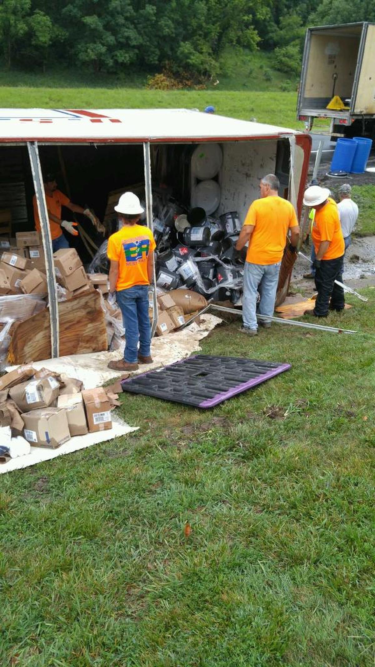 The tractor-trailer rolled onto its side on Interstate 70 near Highland on Thursday. Many of the containers it was hauling — mostly various containers of paint — were damaged and began leaking.