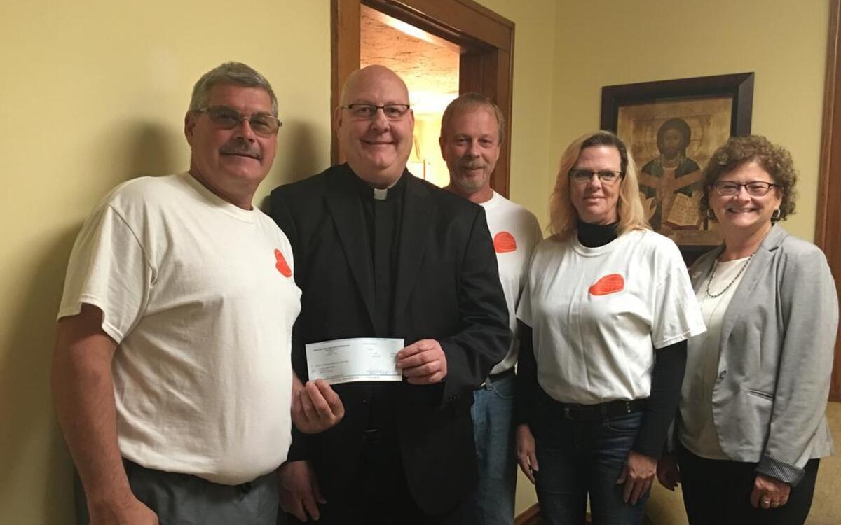 From left are Steve Frey, Father Pat Jakel, Randy Kohlbrecker, Tina Fohne, and Principal Kathy Sherman.