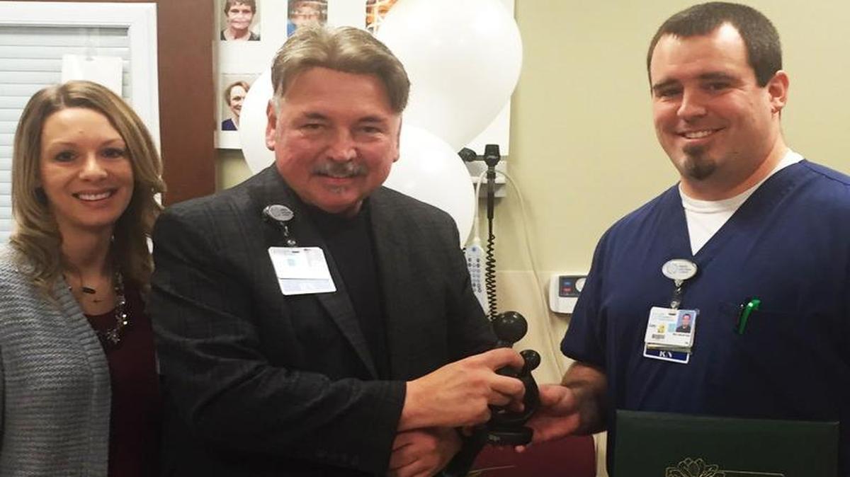 Cory Lucas (right), a registered nurse at HSHS St. Joseph’s Hospital in Highland, receives the hospital’s first DAISY Award from Teresa Cornelius, director of clinical services, and John Ludwig, CEO and president of St. Joseph’s Hospital.