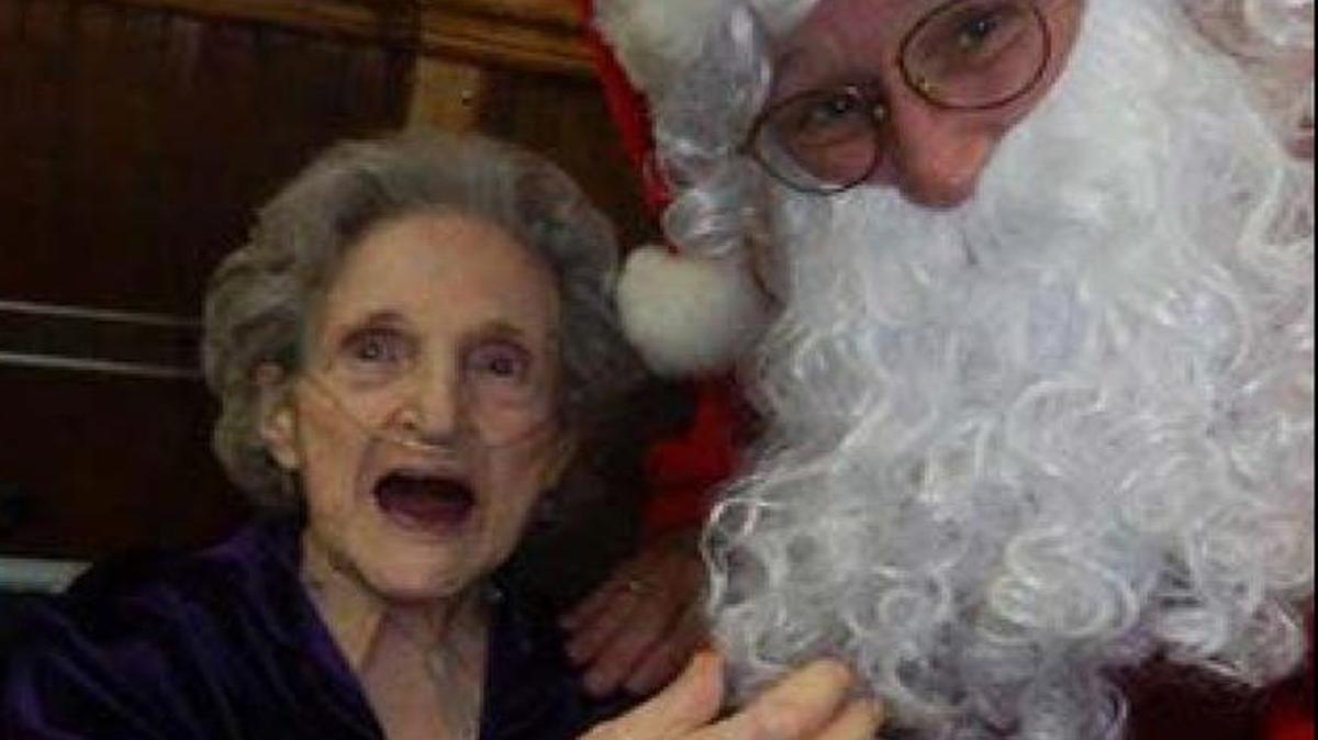 Santa came to visit with the residents of Alhambra Care to share his bag of gifts. Juanita Grothaus, with a twinkle in her eye gave a small tug on Santa's beard to make sure he was the true Santa.