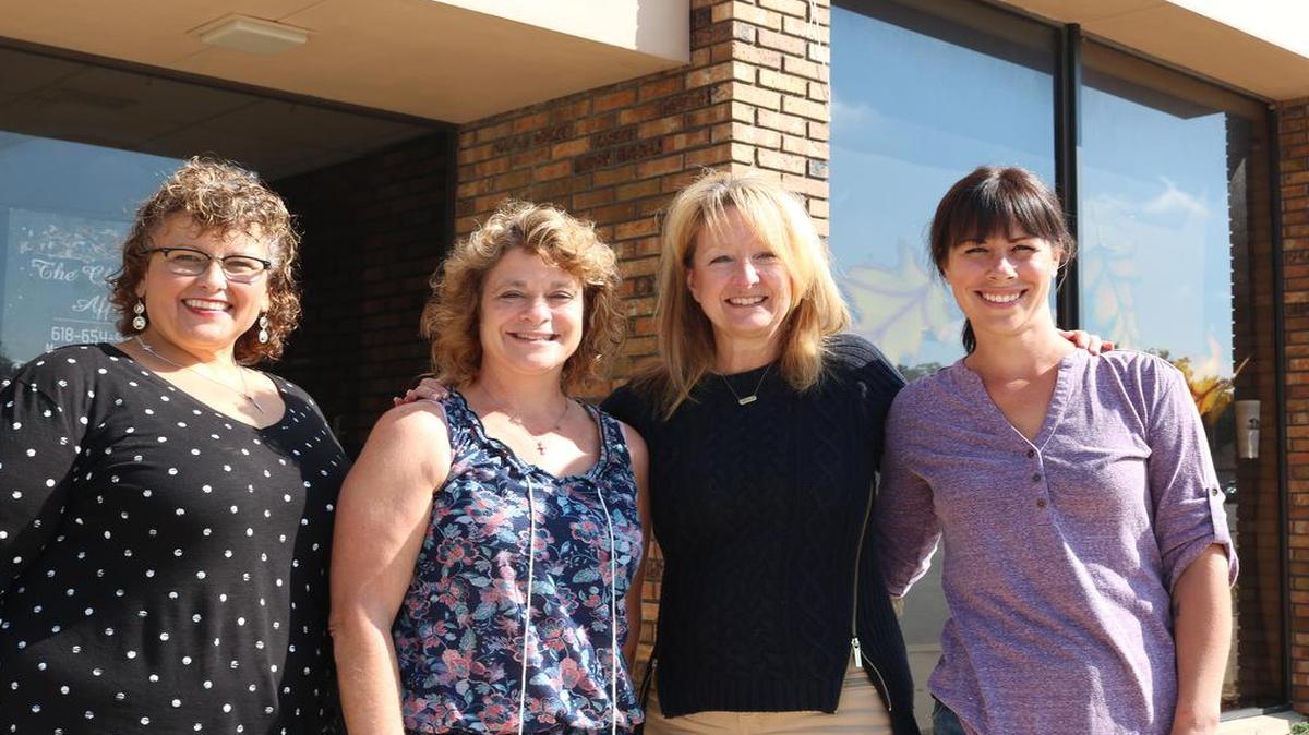 From left to right, Judy Neier of Highland Printers, Traci Reichmann of Leaps of Love, Terry Aebischer from Travel One and Jen Libbra from The Chocolate Affair, have become business neighbors since their establishments have moved into the same office building, located at 1005 and 1011 Broadway of the last few months. Not pictured, a representative from the Lions Club, which also moved into the office space.