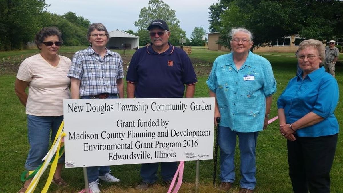 From left are New Douglas Trustee Judy Klein, Trustee Nancy Zweck, New Douglas Township Supervisor Duane Schallenberg, Gardener Peggy Dunn, and New Douglas Mayor June Ridens stand near the New Douglas garden which will feed families in need for free.