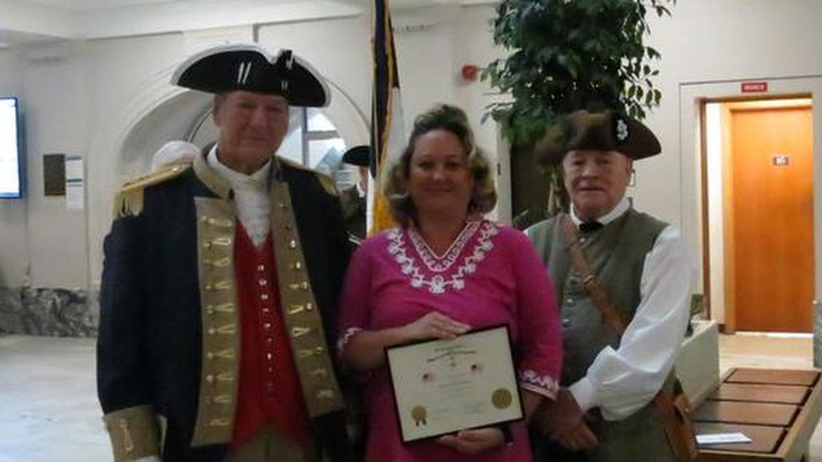 Gen. George Rogers Clark Chapter SAR president Charles Dobias and member Philip Bailey. present a certificate to Jennifer Sparks of Hamel Township for flying the American flag.