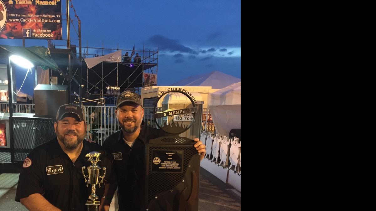 
Aaron Vogel, on left, a 1993 Highland High School graduate and owner of Cackle & Oink BBQ from Sherman, Texas, along with teammate JR Larsen, a 1994 HHS graduate, pose with the hardware they won at this year’s Memphis in May World Championship Barbecue Cooking Contest.
