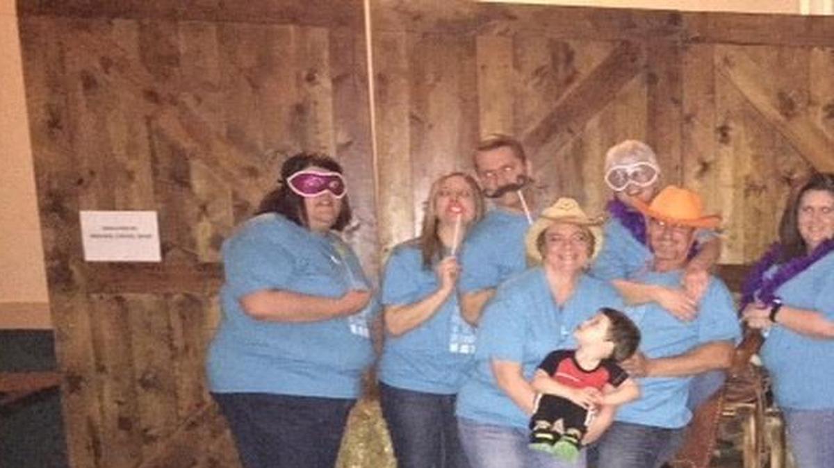 Posing in the photo booth at the kickoff for Highland’s Relay for Life are Relay Committee members, from left, Joy Krouper, event lead and social media chair; Lisa and Keith Henss, entertainment chairs; Julie (holding grandson Chayton Lewis) and Mike Hanna, logistic chairs; Kathy Walker, survivor chair; Barbie Nix, fundraising chair; Emily McDowell, team recruitment chair; Paula Redman, sponsorship and publicity chair; and Karie Schuck, Luminaria chair.