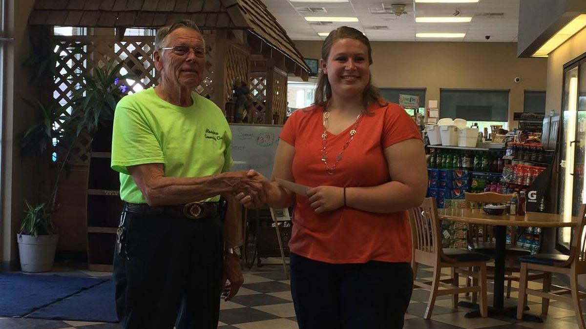 Alhambra Community Club Scholarship winner: Alhambra Community Club member Louie Knackstedt presents a check to Cami Ernst, the winner of this years Community Club Scholarship.