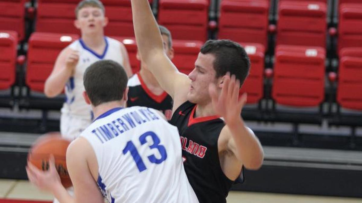 Highland junior forward Sam LaPorta plays tough defense on Bethany Okaw Valley’s Ty Nichols during the Bulldogs’ 56-30 victory over the Timberwolves on Friday afternoon at the Effingham St. Anthony Thanksgiving Tournament.