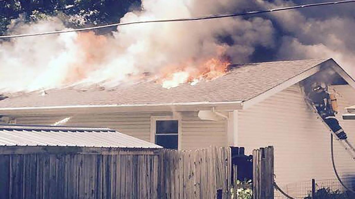 A firefighter battles a blaze at 205 St. Jacob Court in St. Jacob Thursday afternoon.