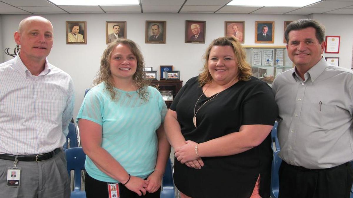 From left are Assistant Superintendent Derek Hacke, Highland Middle School geography teacher Dawn Hubbard, Highland Middle School geography teacher Elizabeth Weder, and Business Education Alliance Chairman Kevin Hemann. Hubbard and Weder were awarded the BEA’s Impact Grant to fund their new geocaching geography program.
