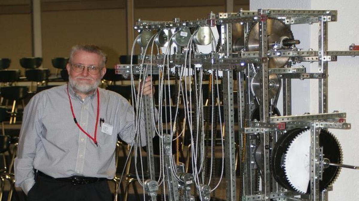 Garland Edwards of Pierron stands next to his invention, The GravPower Generator, which makes electricity using gravity.
