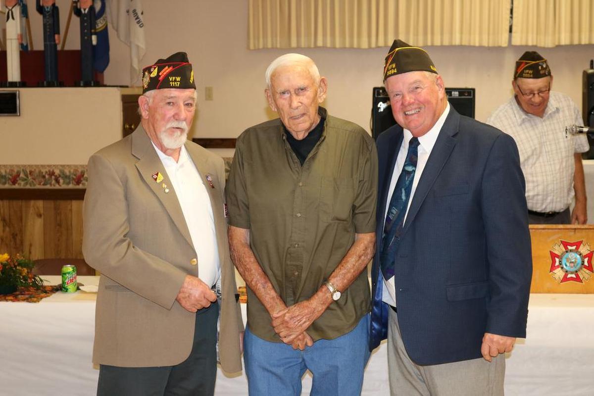 VFW 60-year pin A VFW 60-year pin presented to Wesley Haberer, center, by state assistant membership director Lee Wallace, left, and by VFW Post 5694 commander Mike Voegele, right.